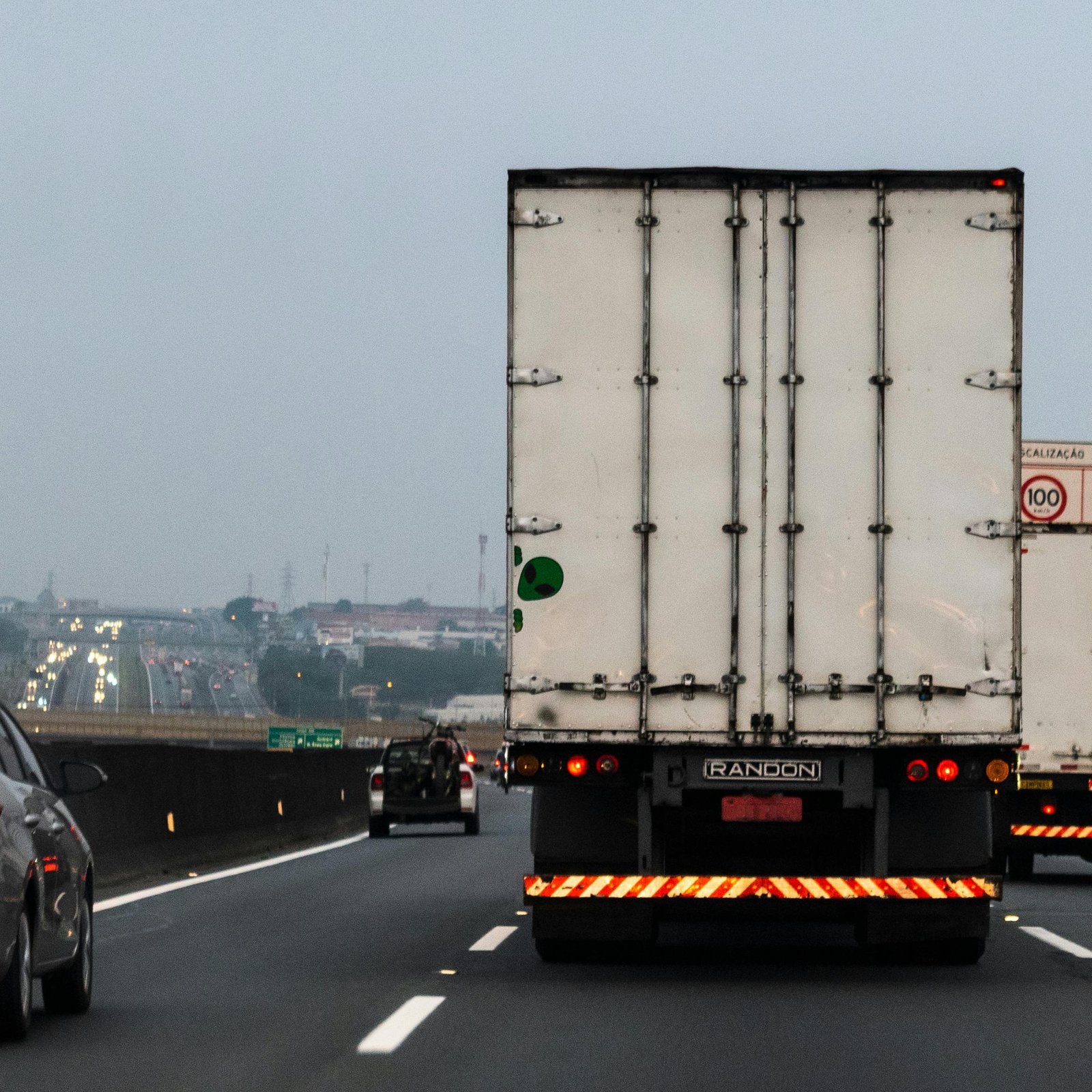 Rear view of a truck on a foggy highway in Sumaré, Brazil, showcasing logistics transportation.